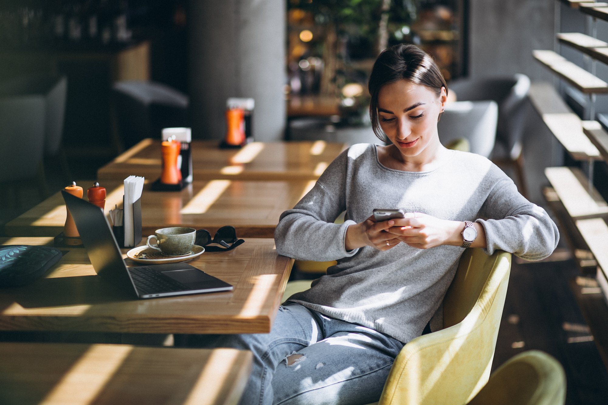 woman-sitting-cafe-drinking-coffee-working-computer