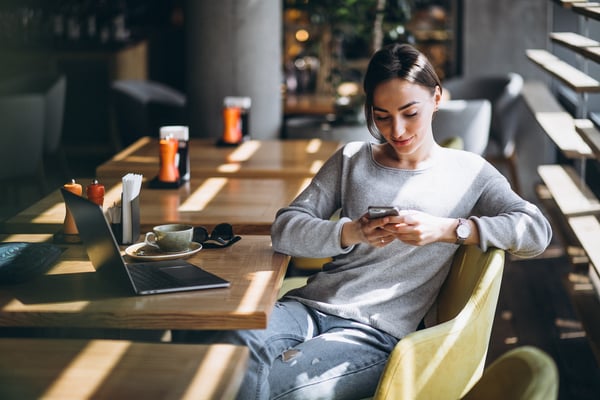 woman-sitting-cafe-drinking-coffee-working-computer